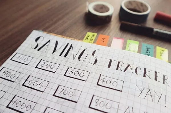 Savings tracker on a wooden surface