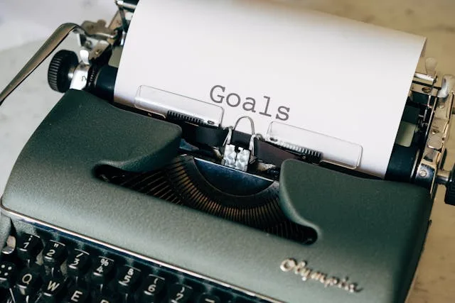 Typewrite with a paper inside with the word Goals